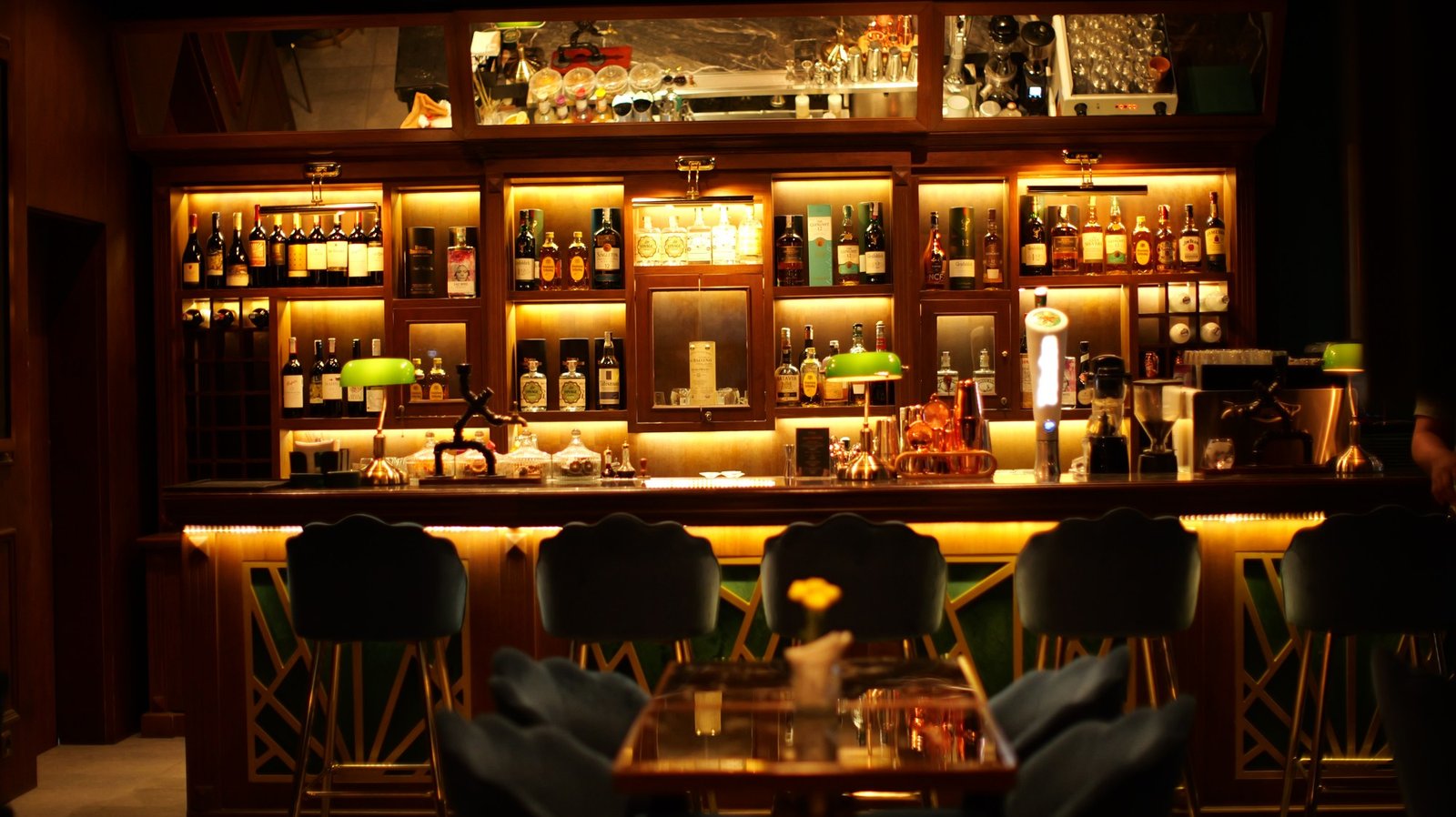 The Bank Bar and Burgers bar lit up in the evening with bottles and warm lighting